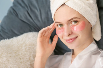 Wall Mural - Young woman with under-eye patches at home