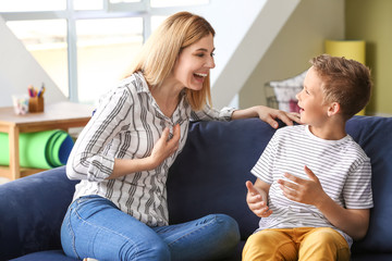 Wall Mural - Happy woman with little adopted boy at home