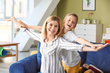 Wall Mural - Happy woman with little adopted boy at home