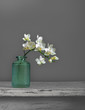 Still life with a branch of a blooming orchid. Minimalism. Vintage.