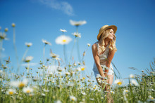 Beautiful Woman In The Field With Flowers. 