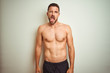 © Krakenimages.com - Young handsome shirtless man over isolated background sticking tongue out happy with funny expression. Emotion concept.