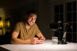 © Krakenimages.com - Young handsome man studying at home , using smartphone, smiling at the camera