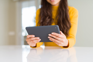 Wall Mural - Beautiful young woman working using touchpad tablet