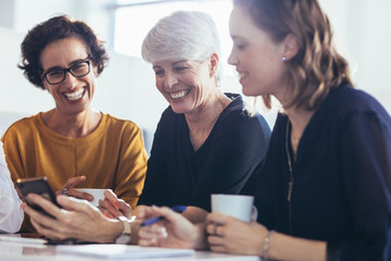 Wall Mural - Three businesswomen during break at office