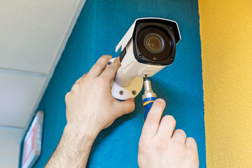 Technician worker installing video CCTV camera