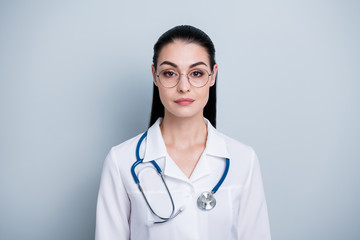 Close up photo beautiful amazing she her lady young doctor first working day hospital ready begin start strict not smiling wear phonendoscope white science costume specs isolated grey background