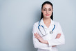 © deagreez - Close up photo beautiful amazing she her lady young doctor first working day hospital ready begin start crossed arms friendly wear phonendoscope white science costume specs isolated grey background