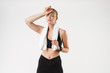 © Drobot Dean - Image of caucasian exhausted woman wearing tracksuit touching her head with towel