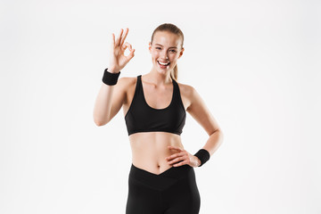 Sticker - Image of caucasian sporty woman wearing tracksuit smiling and gesturing ok sing