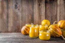 Autumn Winter Food. Pumpkin Puree In Different Glass Jars,with Spices, Wooden Background Copy Space