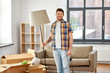 © Syda Productions - moving, people and real estate concept - happy man with floor lamp at new home