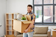 © Syda Productions - moving, people and real estate concept - happy man with boxes at new home