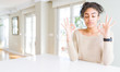 © Krakenimages.com - Beautiful young african american woman with afro hair sitting on table at home relax and smiling with eyes closed doing meditation gesture with fingers. Yoga concept.