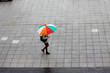 Person with umbrella walking in the city in a rainy day
