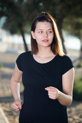 Wall Mural - Female 20-30 years old is jogging in black T-shirt