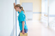 © pikselstock - Tired female nurse in hospital corridor