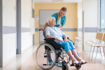 Wall Mural - Senior woman in wheelchair with nurse in hospital