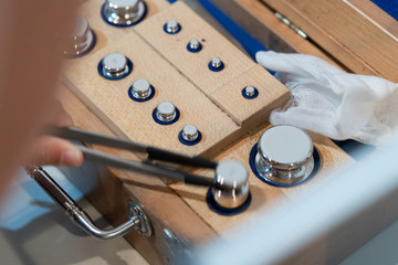 Wall Mural - Stainless steel calibration weight to place on the analytical balance for calibration test.