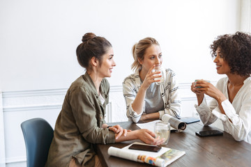 Poster - Group of cheerful young women studying together