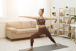 © Prostock-studio - Fitness Concept. Yoga Woman Training In Cozy Living Room