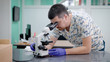 © kustvideo - Doctor in laboratory looking through microscope