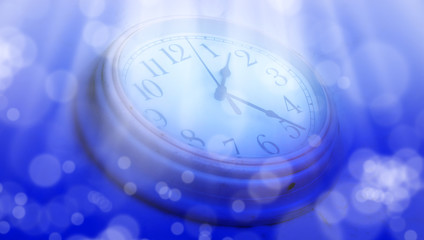 Wall Mural - abstract defocused lights and close up clock face over blue background