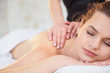 © gorynvd - Handsome relaxing woman during massage in spa salon.