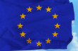 © kittyfly - beautiful national flag of the European Union on soft silk with soft folds close-up against the blue sky with clouds, the concept of friendship, unity, cooperation, international union