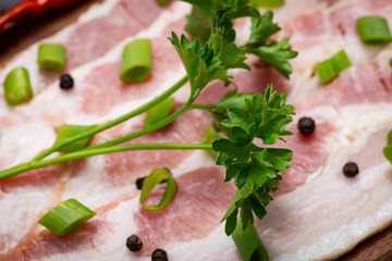 Wall Mural - Uncured Apple Smoked Bacon garnished with Chopped Green Scallions, Fresh Curly Parsley, Rainbow Peppercorns and dried Red Chile De Arbol Pepper. 