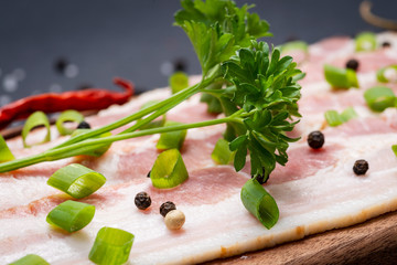 Wall Mural - Uncured Apple Smoked Bacon garnished with Chopped Green Scallions, Fresh Curly Parsley, Rainbow Peppercorns and dried Red Chile De Arbol Pepper. 