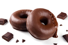 Delicious Fresh Chocolate Donuts With Pieces Of Chocolate On White Background. Appetizing Tasty Glazed Donuts Ready To Eat Among Pieces Of Chocolate On White Background.