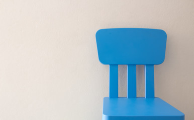 blue chair in front of the wall