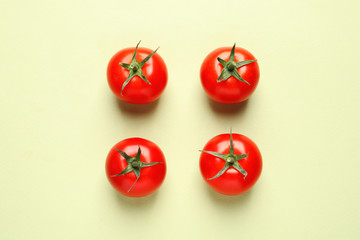 Flat lay composition with ripe cherry tomatoes on color background