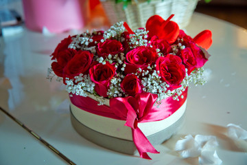 Heart shaped bouquet of beautiful rose flowers in the gift box . Handmade pink and red bouquet Rose In Love hart Shape Valentine in close-up . a box in the shape of a heart with burgundy roses