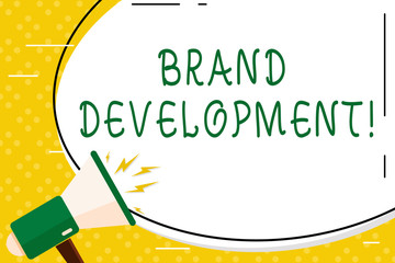 Writing note showing Brand Development. Business concept for improving customers knowledge and opinions of a brand Oval Shape Sticker and Megaphone Shouting with Volume Icon