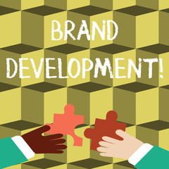 Writing note showing Brand Development. Business concept for improving customers knowledge and opinions of a brand Hands Holding Jigsaw Puzzle Pieces about Interlock the Tiles