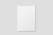 © PrimeMockup - Blank realistic spiral bound notepad mockup on light grey background. High resolution.