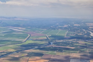 Rural farmland around Sacramento aerial from airplane, including view of rural surrounding agricultural fields, rivers and landscape. California, United States.