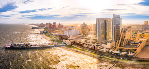 Fototapete - Late afternoon aerial panorama of Atlantic city along the boardwalk. Atlantic City achieved nationwide attention as a gambling resort and currently has nine large casinos.