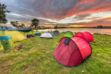 Canvas Print - Camping spot with dome tents near lake