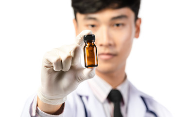 Asian scientist hand holding empty small brown medicine bottle .