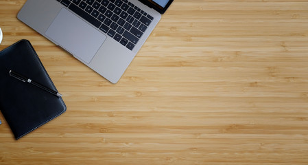 Workspace laptop with diary book and copy space