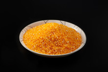 Close-up Of A Dish Of Golden And Yellow Grains Full Of Corn Kernels