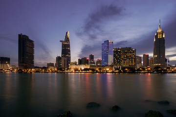 Wall Mural - The best of night view in Ho Chi Minh City, Vietnam. Colorful of city light beside the Saigon river with skyline at sunset. Royalty high quality free stock image.