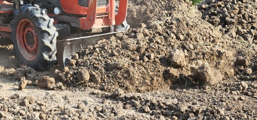 Canvas Print - tractor push clot soil after pour from truck