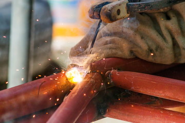 People working on welding steel in industrial applications.