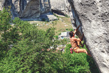 Fototapeta  - Man climbs rock.