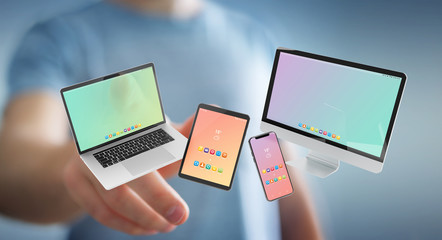 Businessman connecting modern smartphone tablet laptop and computer 3D rendering