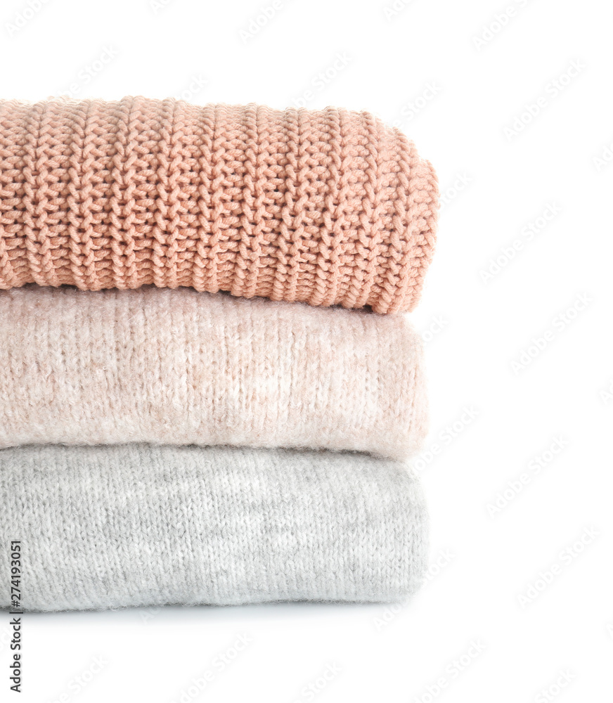Stack of warm clothes on white background